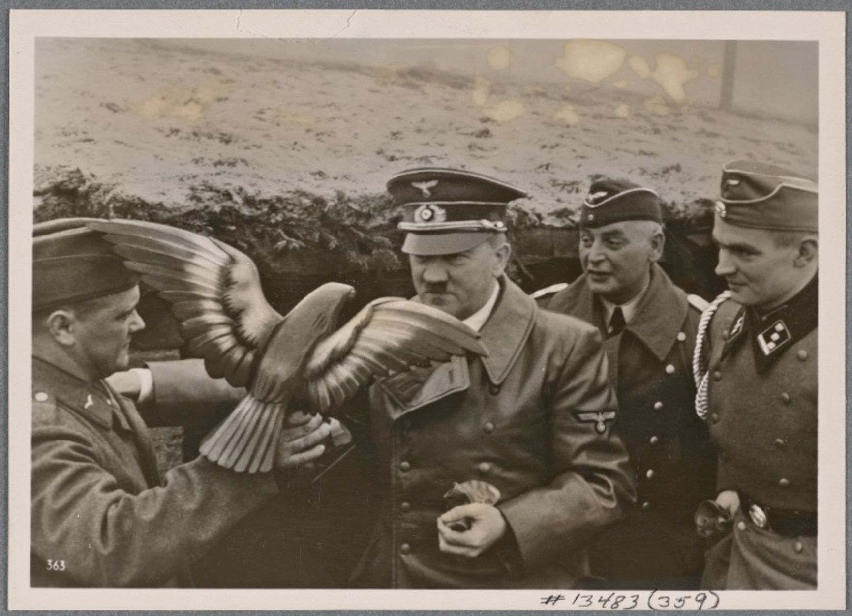 Adolf Hitler receives a carved wooden eagle during his visit to a Luftwaffe airbase. 1939