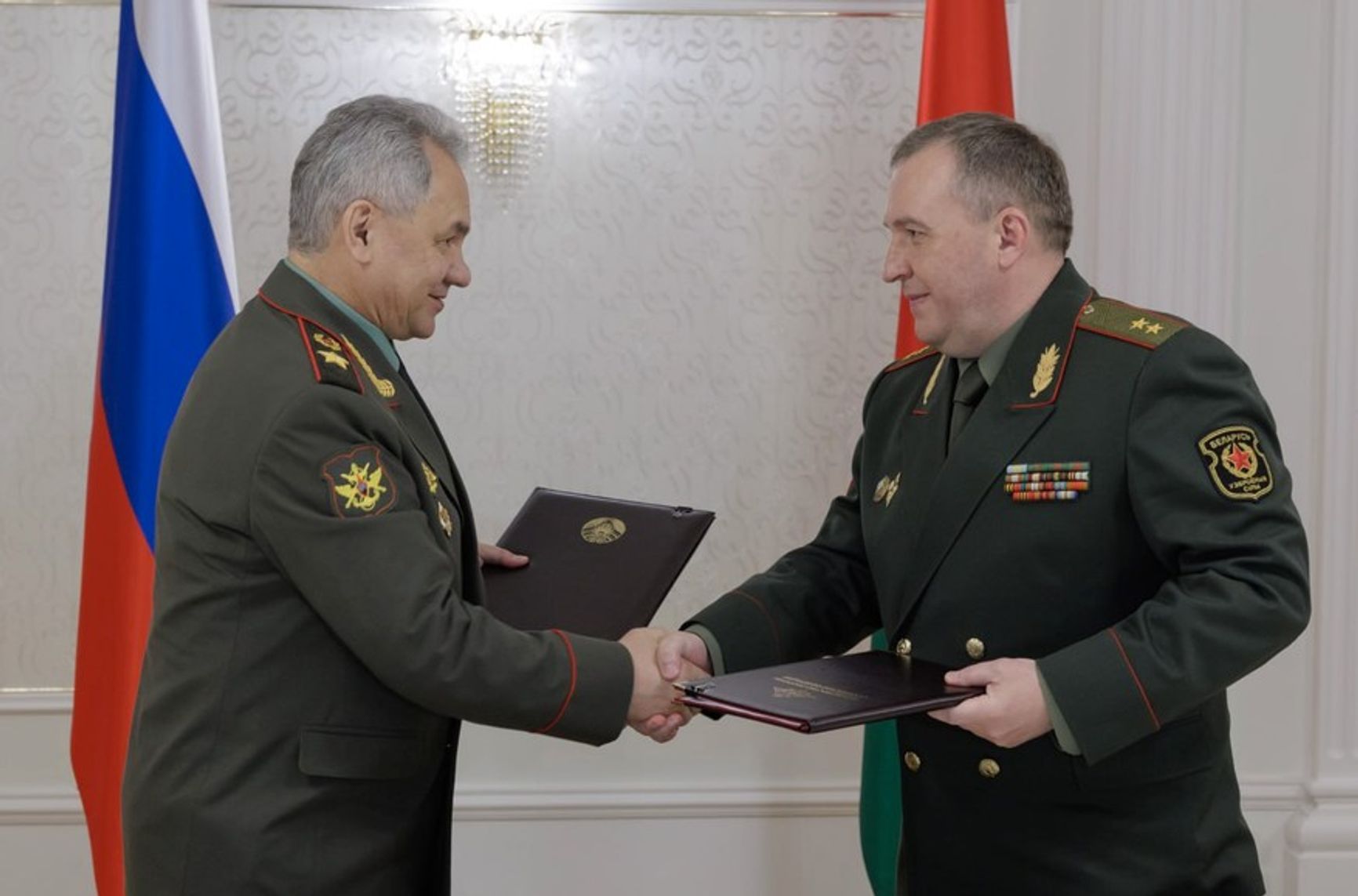Russian Minister of Defense Sergei Shoigu and his Belarusian counterpart Viktor Khrenin after signing the terms of Russian nuclear weapons deployment to Belarus