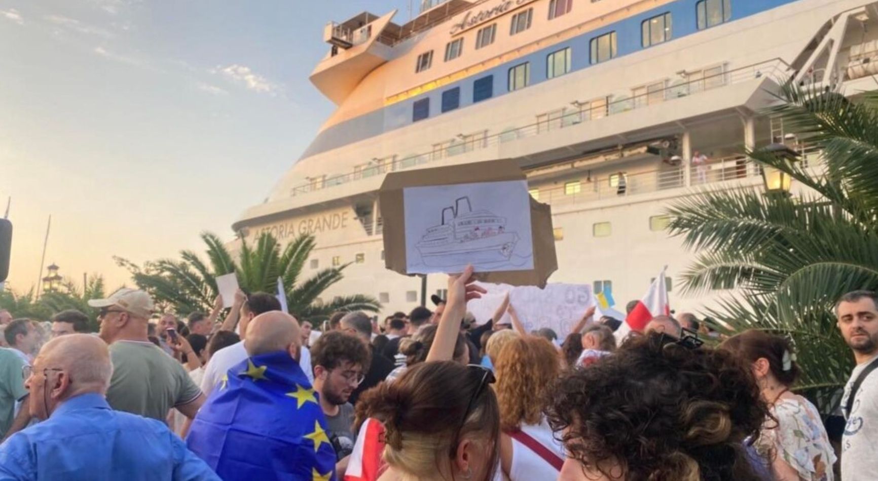 Demonstrators protest the presence of a cruise ship carrying Russian passengers in the Georgian port of Batumi on July 27, 2023