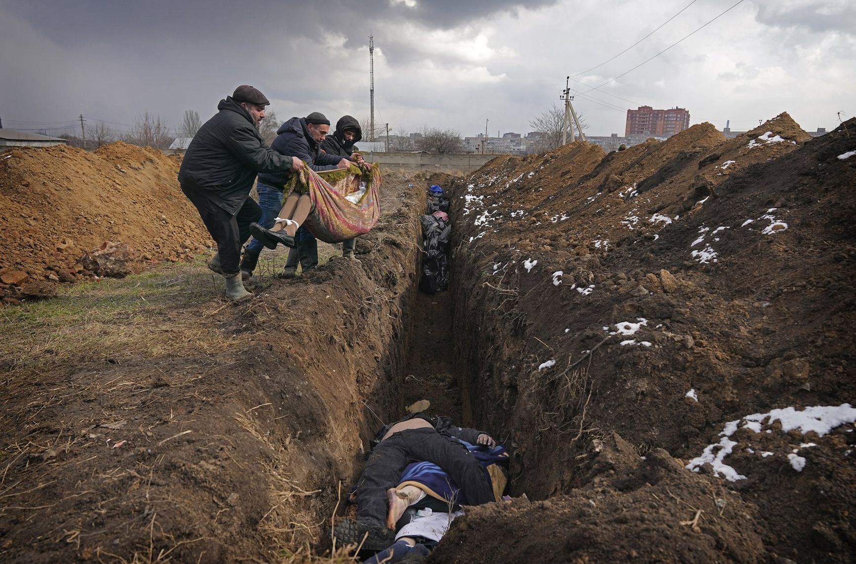 People place dead bodies in a mass grave in an old cemetery in Mariupol, Ukraine. According to the BBC, on some days, up to 150 people a day were buried in mass graves during periods of heavy Russian shelling.