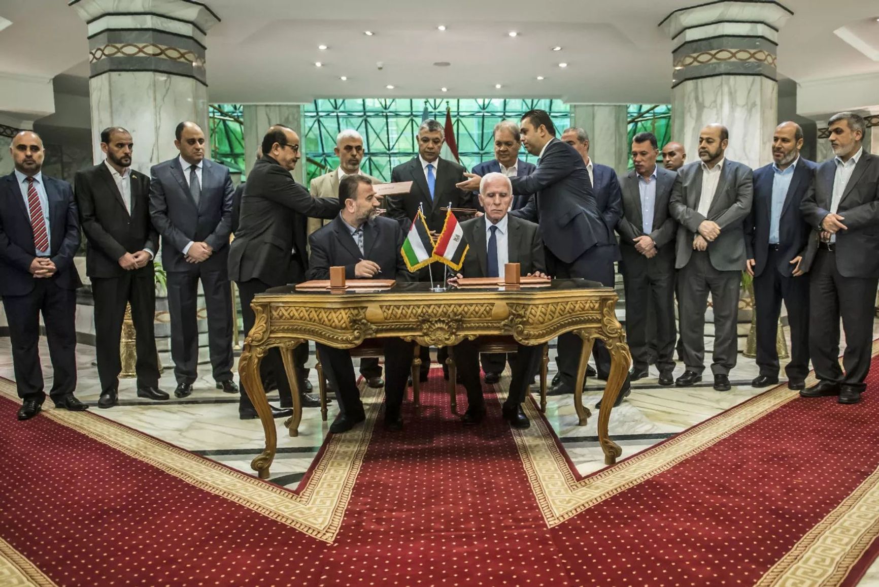 The new deputy leader of Hamas, Salah al-Aruri (sitting on the left), and Azzam al-Ahmad of Fatah (sitting on the right) sign a reconciliation agreement, Cairo, October 12, 2017.