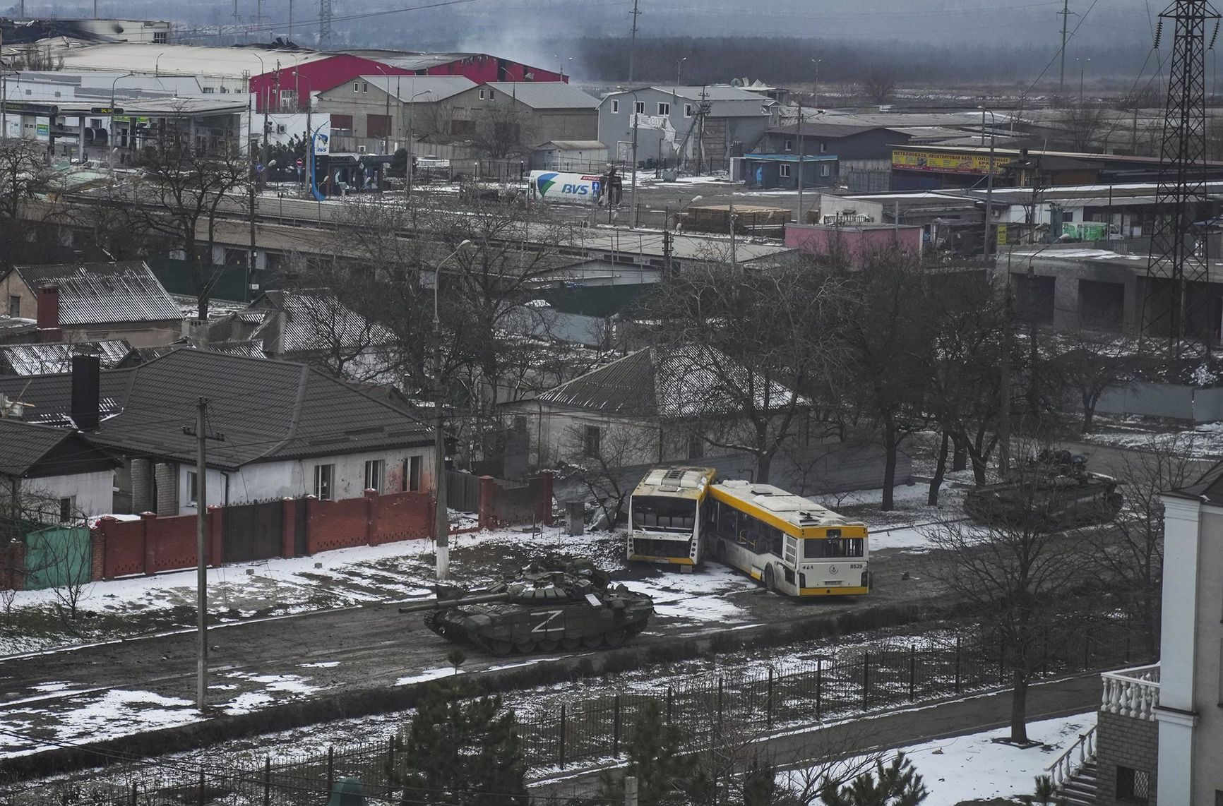 Russian army tanks move through a street on the outskirts of Mariupol, Ukraine.