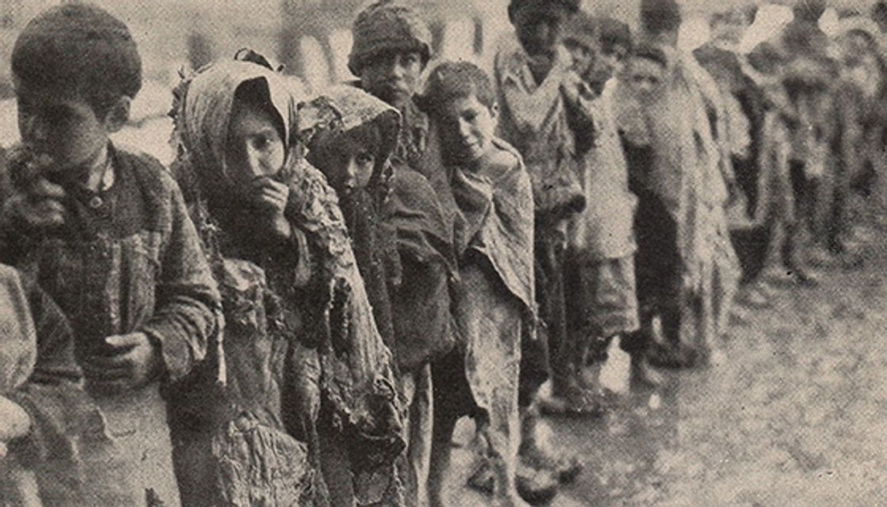 Children waiting in the snow for the opportunity to enter the “City of Orphans”