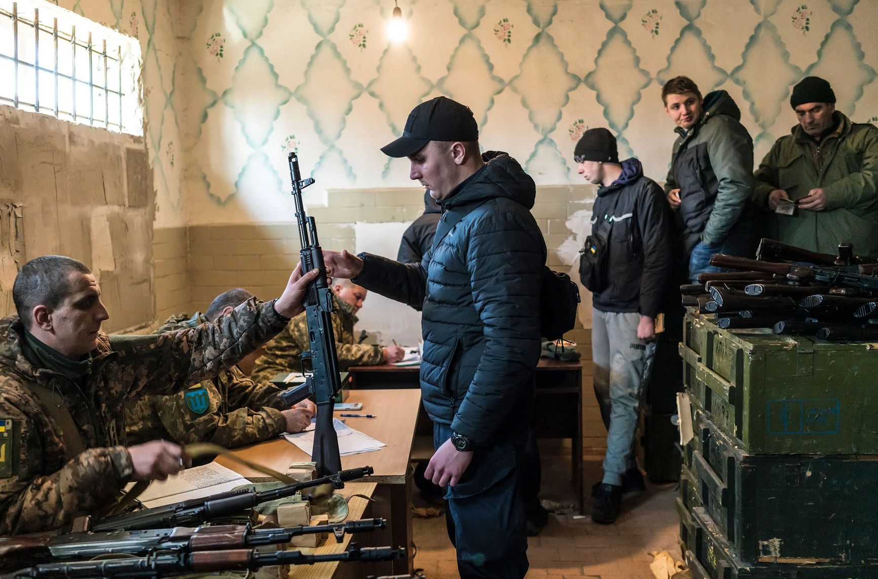 Civilian volunteers receive weapons, in a nationwide campaign to recruit, register and draft men for the war against Russia, in Fastiv, Ukraine, on Feb. 25.