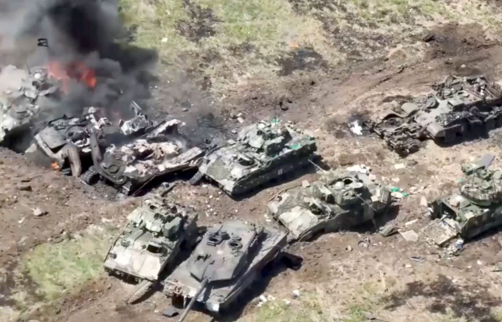 The defeated Ukrainian column with a Leopard tank and Bradley infantry fighting vehicle 