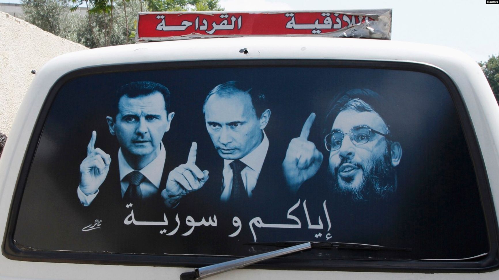 Рисунок на машине, на котором изображены президент Сирии Башар Асад, президент РФ Владимир Путин и лидер «Хезболлы» Сайед Насралла. Латакия, Сирия, май 2014 года