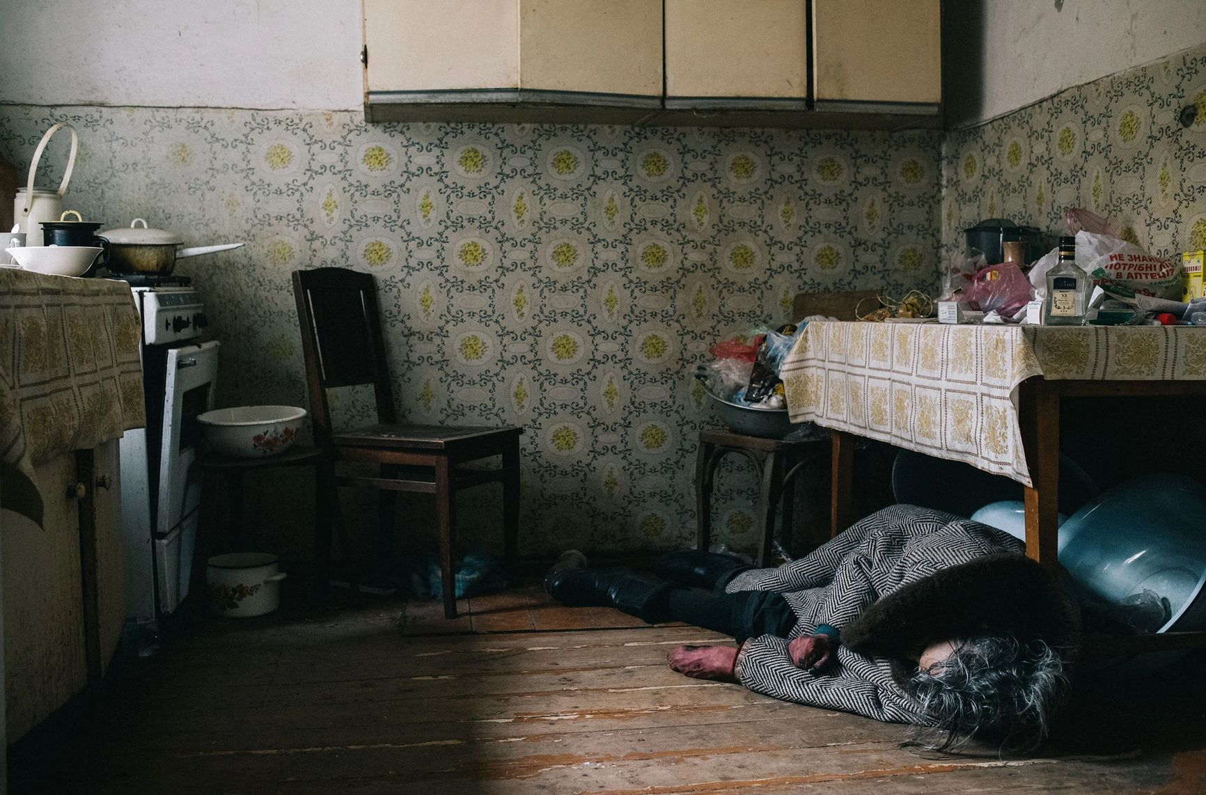 The victim of a mortar attack in Bucha lies in her kitchen on April 6.