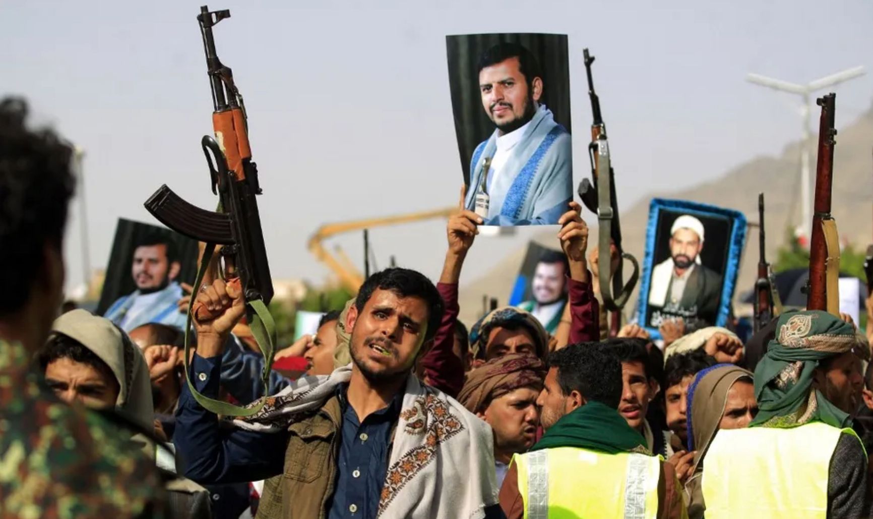 Houthis with portraits of Abdul-Malik Al-Houthi during a demonstration in Sanaa, 2022