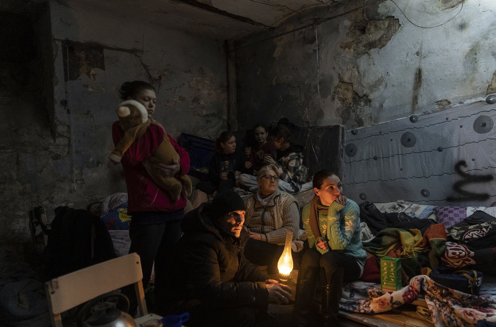Zhanna Goma (right) and her neighbors settle in a bomb shelter in Mariupol, Ukraine.