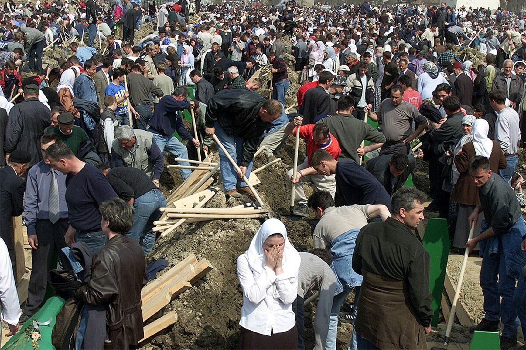 Relatives of those killed during the massacre in Srebrenica in 1995 bury the remains of their loved ones in a city field on March 31, 2003