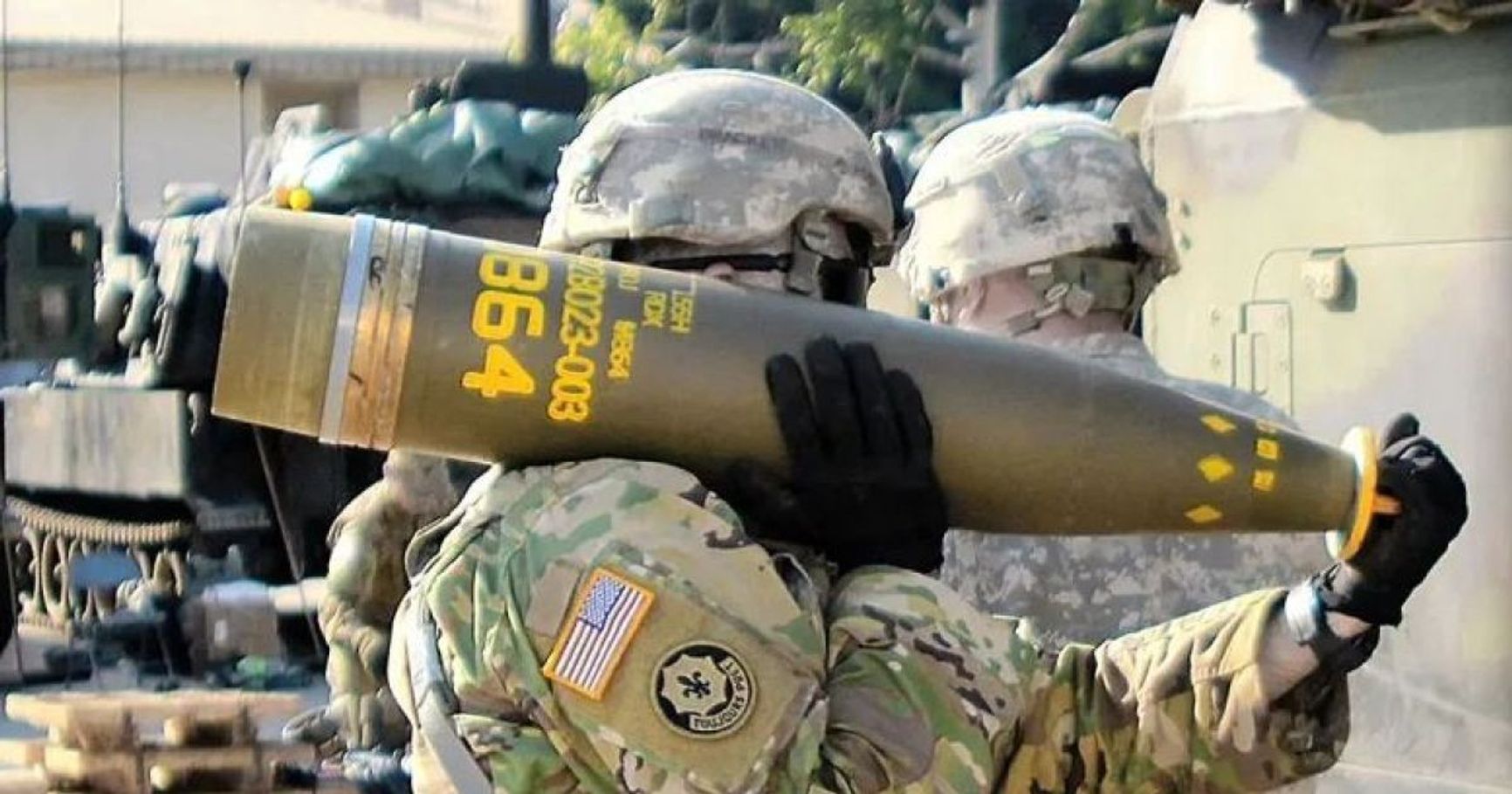 Американский солдат несет кассетный снаряд DPICM M864