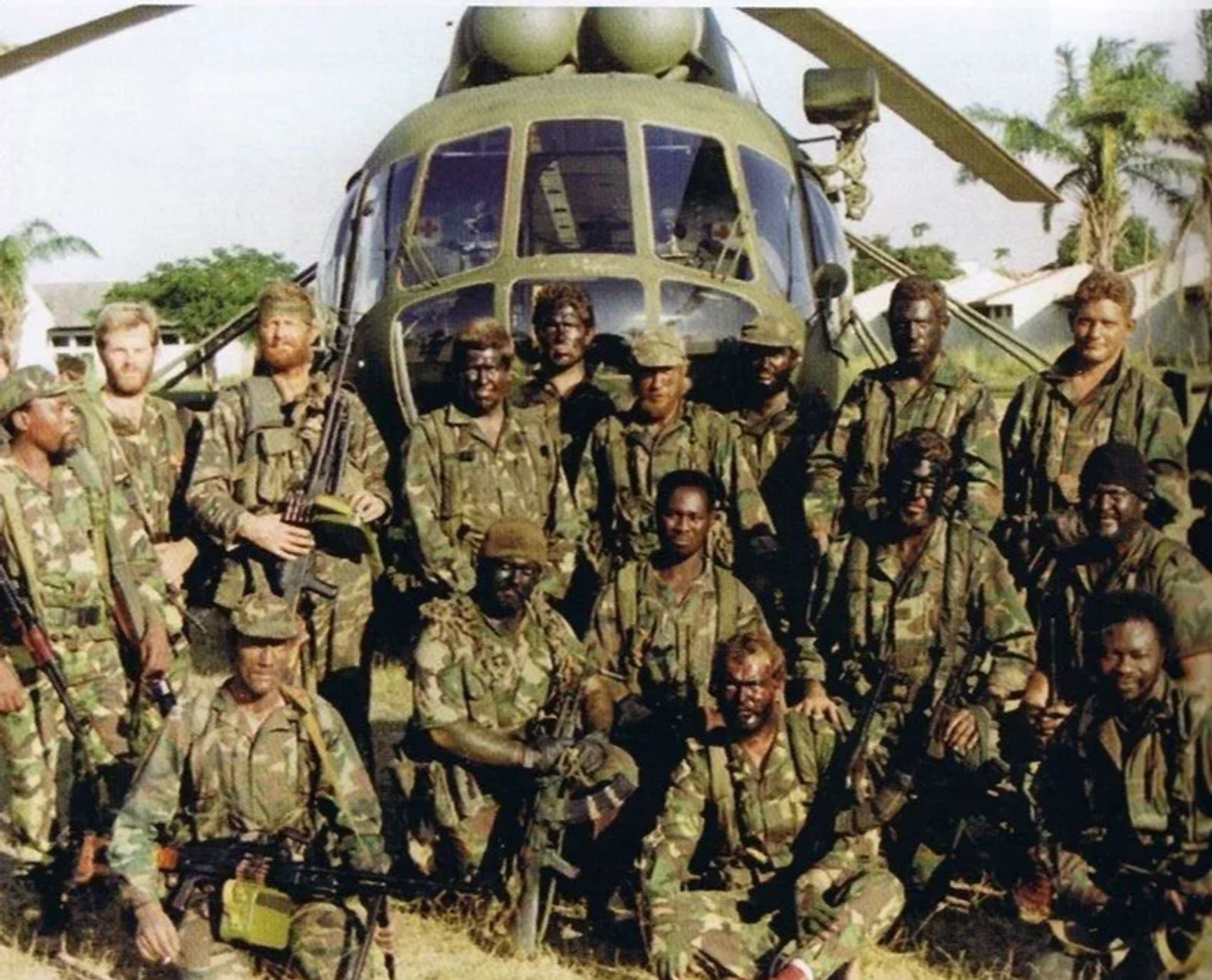 Executive Outcomes employees in Sierra Leone against the backdrop of a Mi-17