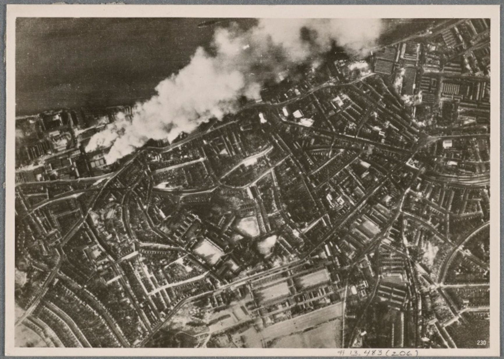 A photo in a German newspaper illustrating a report on the bombing of London. The city's docks and warehouses are on fire after Luftwaffe raids. 1940