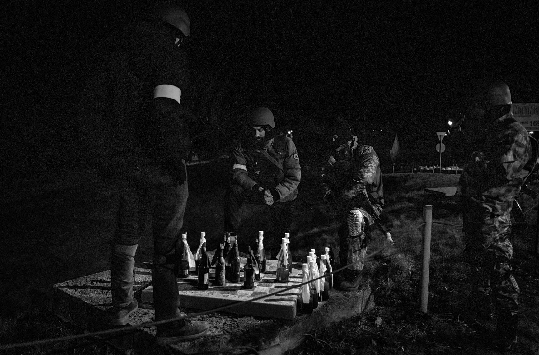 Members the Territorial Defense Forces who guard a large checkpoint briefly played a game of checkers with Molotov cocktails, as seen on the eastern outskirts of Kyiv, Ukraine, on March 5. With few vehicles passing because of the nighttime curfew, Territorial Defense members can have a moment of quiet while remaining on high alert for any suspicious activity.