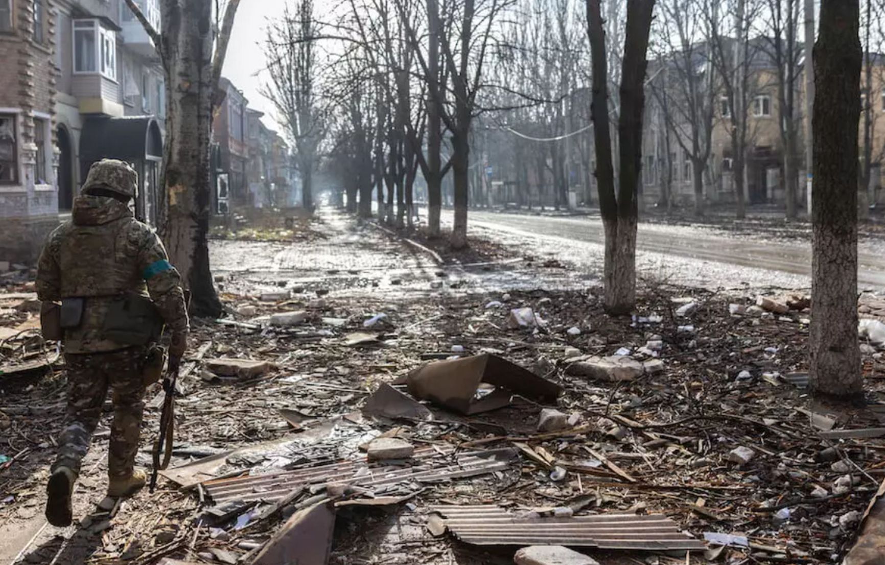 Military servicemen on the nearly destroyed streets of Bakhmut