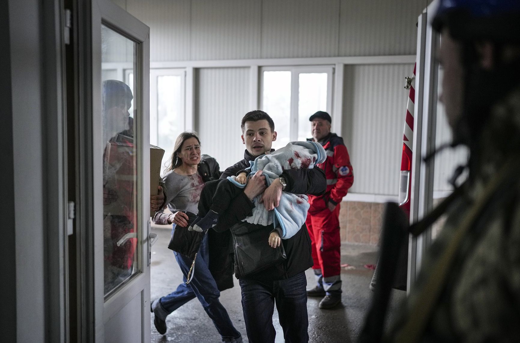 Marina Yatsko and her boyfriend Oleksandr Kulahin bring her 18-month-old son Kirill, fatally wounded during shelling, to a hospital in Mariupol, Ukraine.