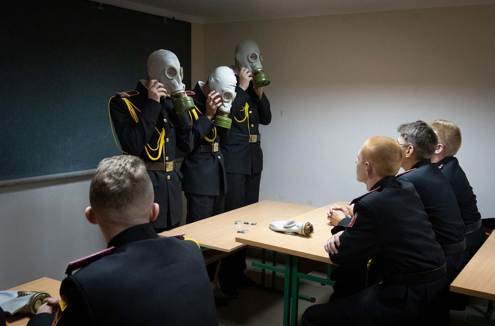 Cadets practice an emergency situation during a lesson in a bomb shelter on the first day of school at a cadet lyceum in Kyiv, Ukraine, on Sept. 1.