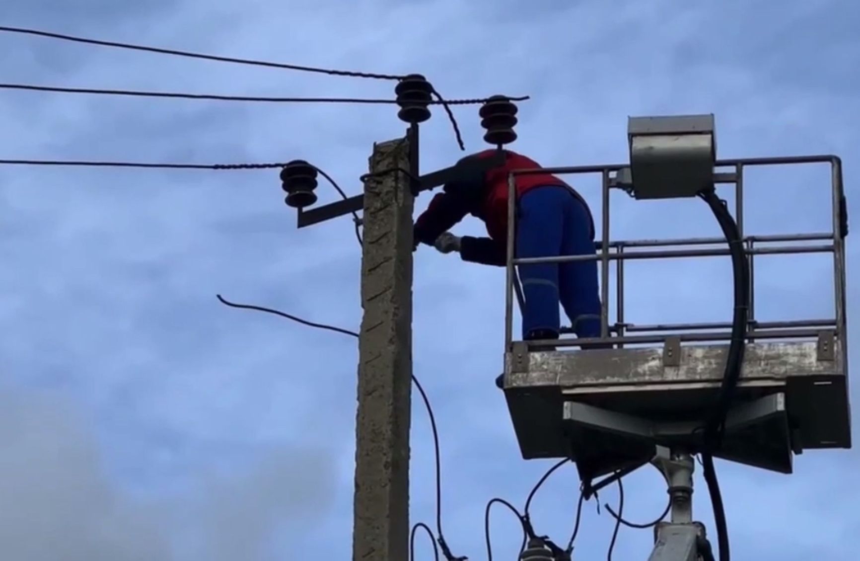Workers remove illegal wires supplying power to a mining farm in Novy Khushet