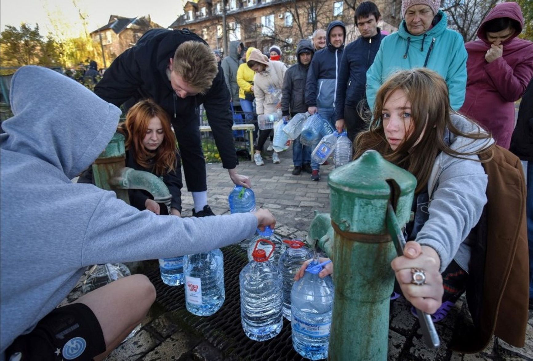 Kyiv residents fetching water from a standpipe in the yard