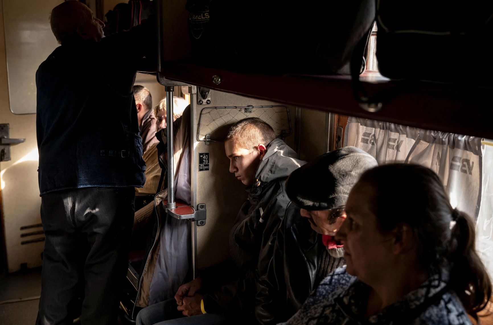 Civilians sit aboard an evacuation train in Pokrovsk, Ukraine, on Sept. 28.